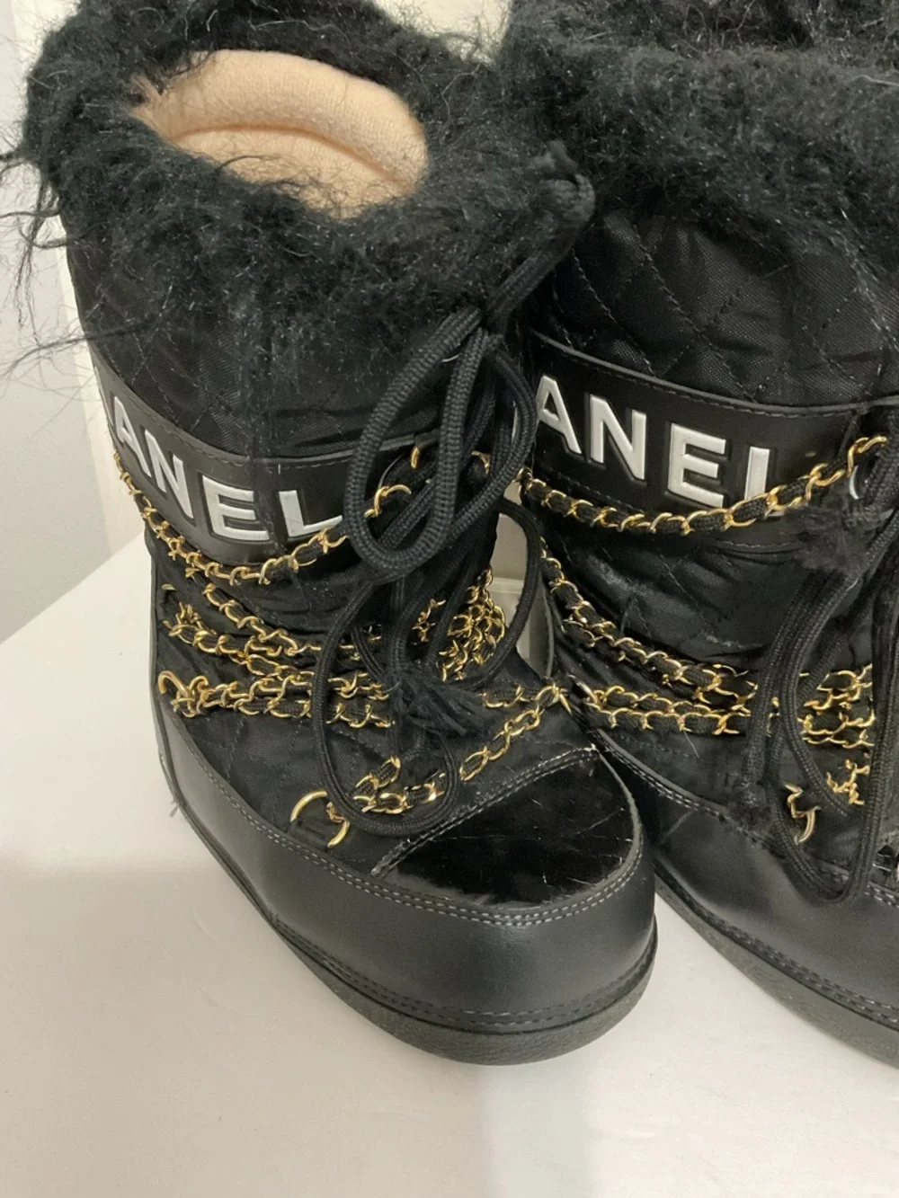 CHANEL Black and Gold Quilted Winter Lace-Up Boots